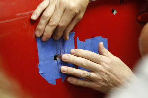 A student measures a bullet hole
