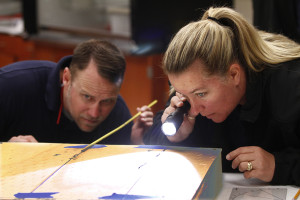 Law enforcement officers study evidence at the National Forensic Academy, an entity within the Institute of Public Service.