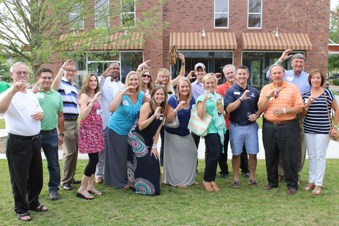 Group of UTC alumni in Knoxville flashing the "Power C"