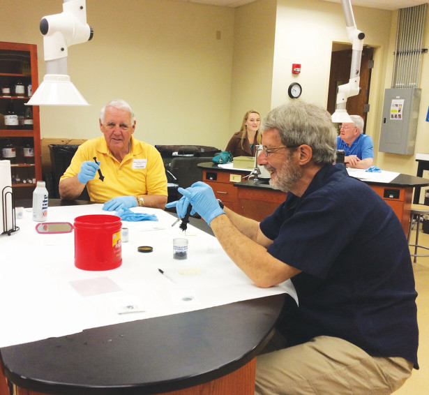  James Wyrosdick (Knoxville ’64) and Richard Redano (Knoxville ’85) get their hands dirty during a fingerprint analysis at the Institute of Public Service’s Law Enforcement Innovation Center. The alumni event was hosted by the Knoxville Region UT Alumni Network.
