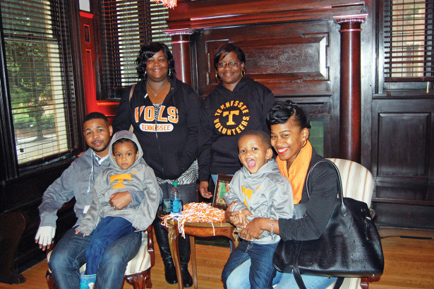 Inky Johnson seated with family members in Tyson Alumni House