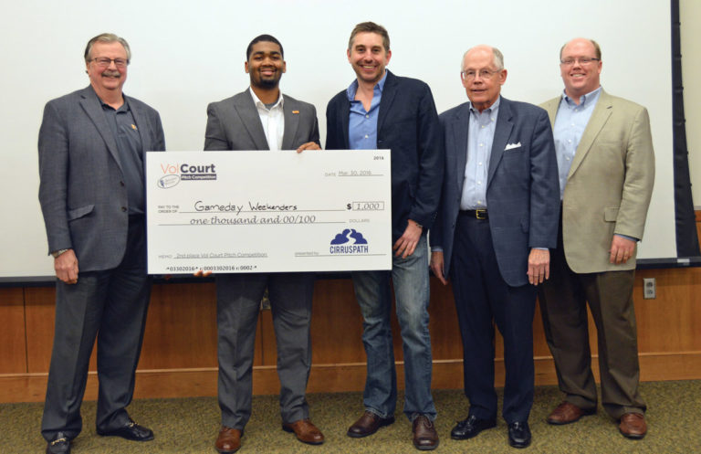 Kevin White, second from left, receives a check for his online company, Gameday Weekenders, after earning second place in the Vol Court Pitch Competition.