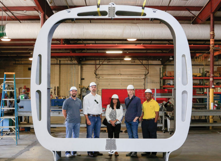 An AMIE 1.0 rib frames (L-R) Gavin Mabe of Clayton Homes, Lucas Tryggestad and Tanvi Parikh of SOM, James Rose of UT and Roderick Jackson of ORNL.