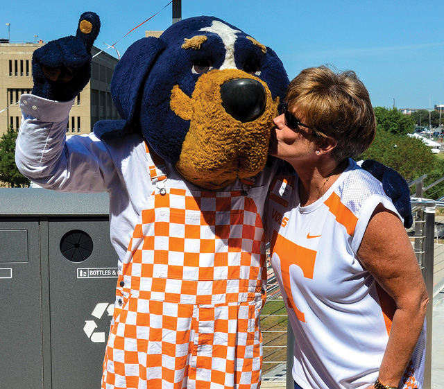 LeeAnn Foster kisses the costumed Smokey
