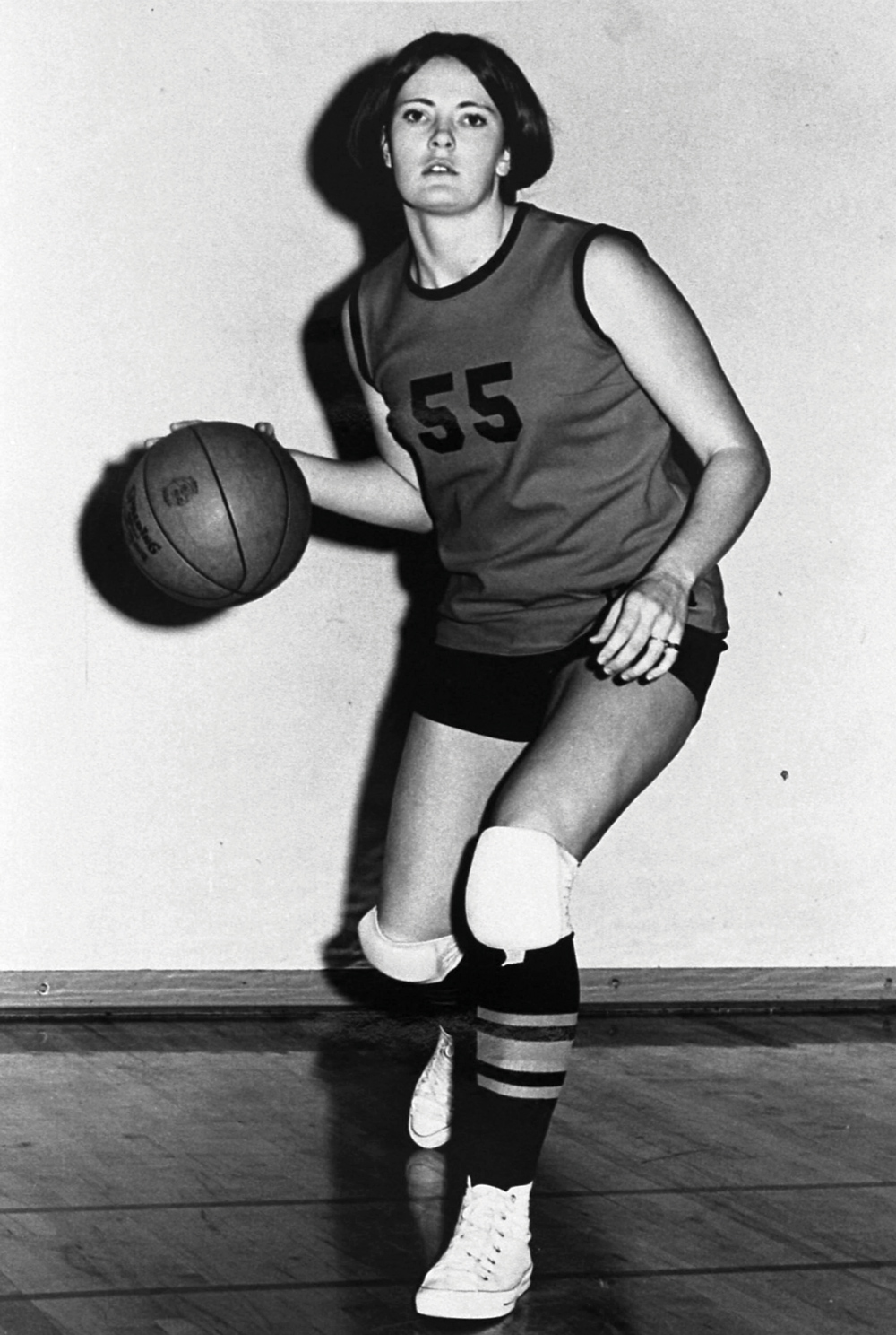 A young Pat Head photographed in her UTM uniform and Chuck Taylors with basketball in hand