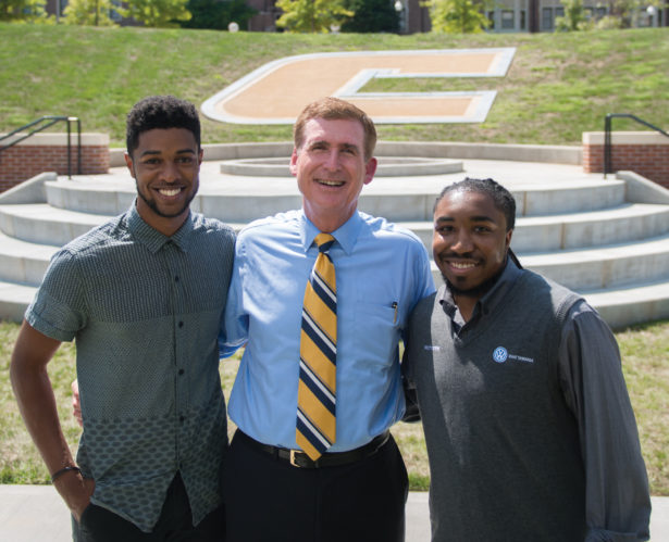 Robert Fisher, a UTC Rhodes scholar (left), and Chancellor Steve Angle join Nathan Harlan (right) in celebrating the reality of Harlan’s idea for a campus Power C.
