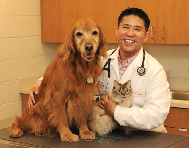 Dr. Ng with a long-haired dog and long haired cat