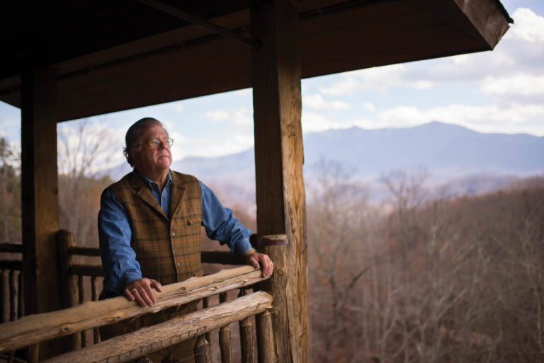 Owner Buddy McLean surveys Great Smoky Mountains National Park from the balcony of a cabin that remained untouched by the 2016 wildfire that destroyed much of his property at the Lodge at Buckberry Creek.
