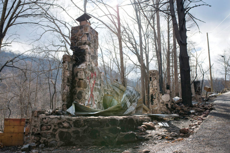 Remnants of a chimney at a burned-out home can be seen on Loop Road near Gatlinburg, Tennessee.