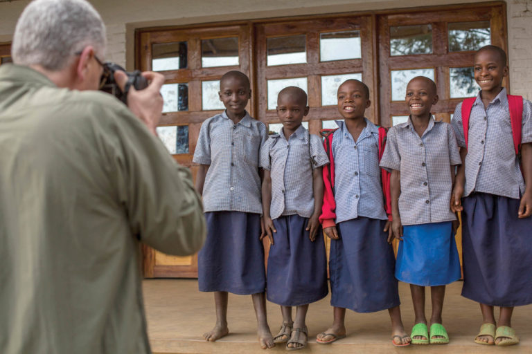 Donnie Smith (CASNR ’80) takes photos of children in a Rwanda village during a programmatic planning meeting for a poultry project partnership with his foundation (the African Sustainable Agriculture Project), the United States Agency for International Development (USAID) and UTIA.