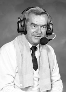 John Ward wearing his broadcasting headset, with a towl draped over his shoulders