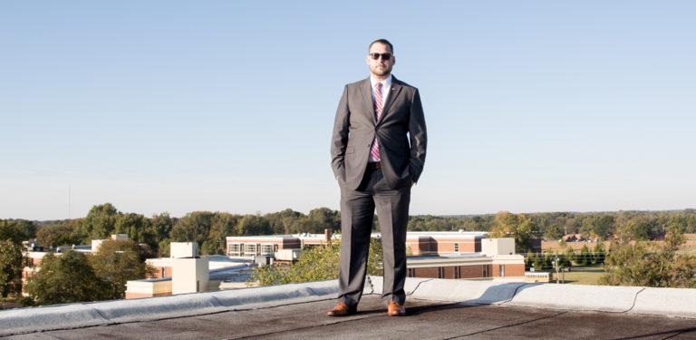 Marcus VanCleave stands on the roof of an academic building looking out at the campus of UT Martin
