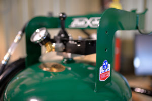 Close up photo of a pressure valve on machinery in Kinion Dunn's shop. A 'Made in Tennessee' decal is slapped on the side