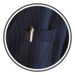 a brass pen clipped in a suit breast pocket