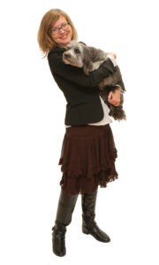 Professor Strand holding a schnauzer in her arms