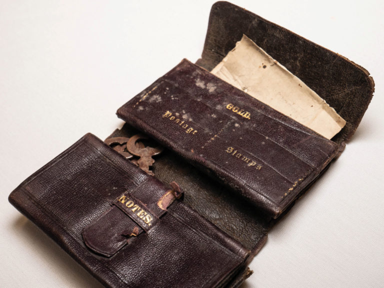 brown antique leather wallet with variety of compartments and gold lettering