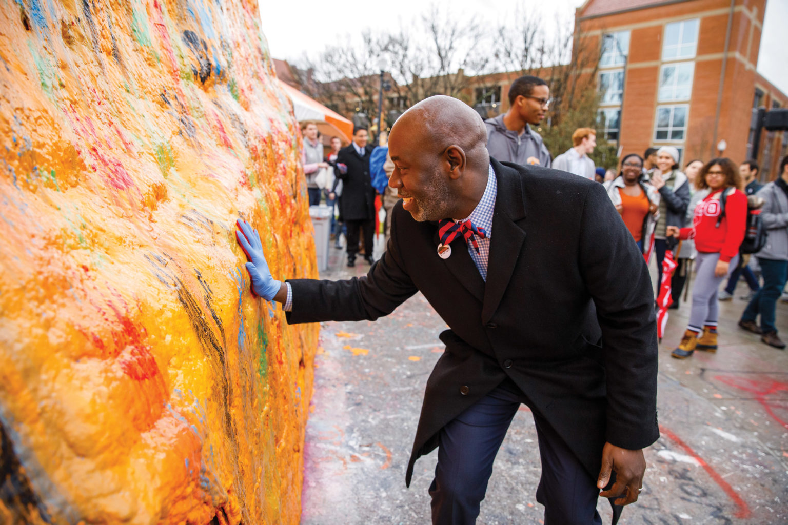 Tyvi Small painting The Rock at UT with his hand print