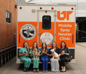 Vet students sit in the back of an ambulance truck modified as a mobile spay neuter clinic